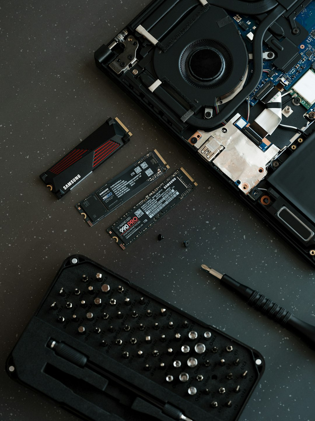 Laptop components and repair tools laid out for upgrade.